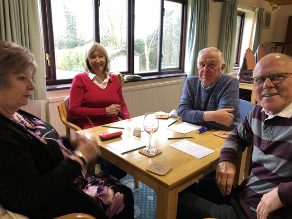 Wendy, Laura, Phil and Alan H at their table, looking at the camera and smiling
