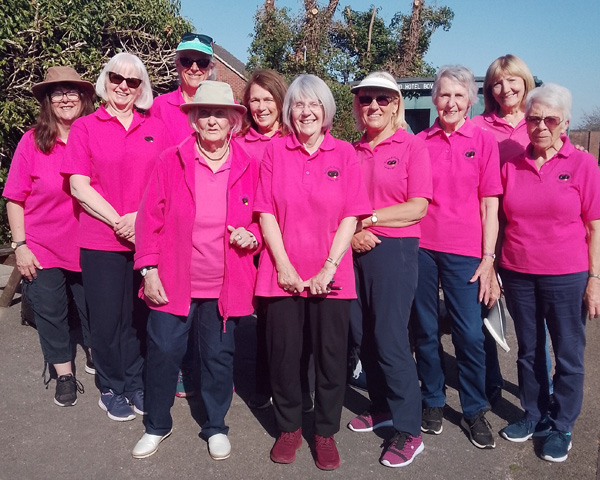 10 of the Burton & Puddington Ladies team posing for a photograph. They are all wearing pink team polos.