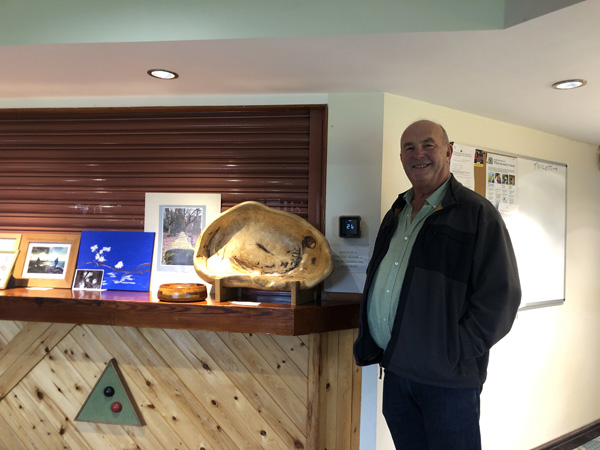 Bob standing by the bar with his large turned dish.