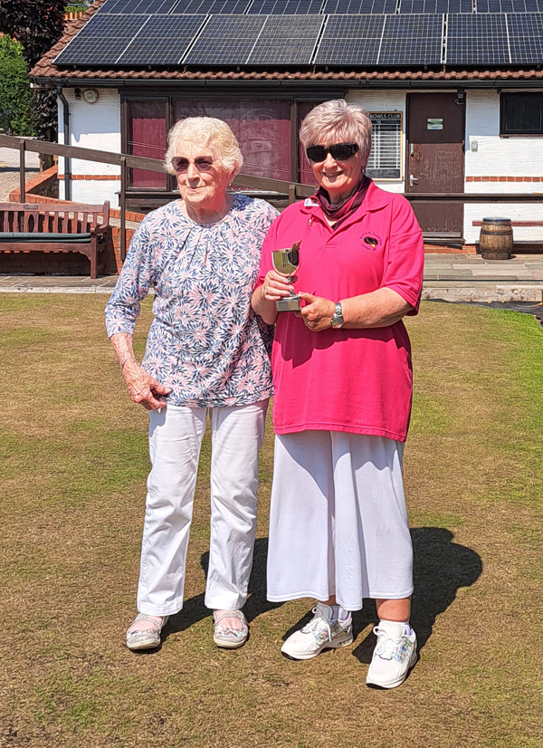 President Dot Lloyd and Runner-Up Wendy posing on the green with the runner-up trophy.