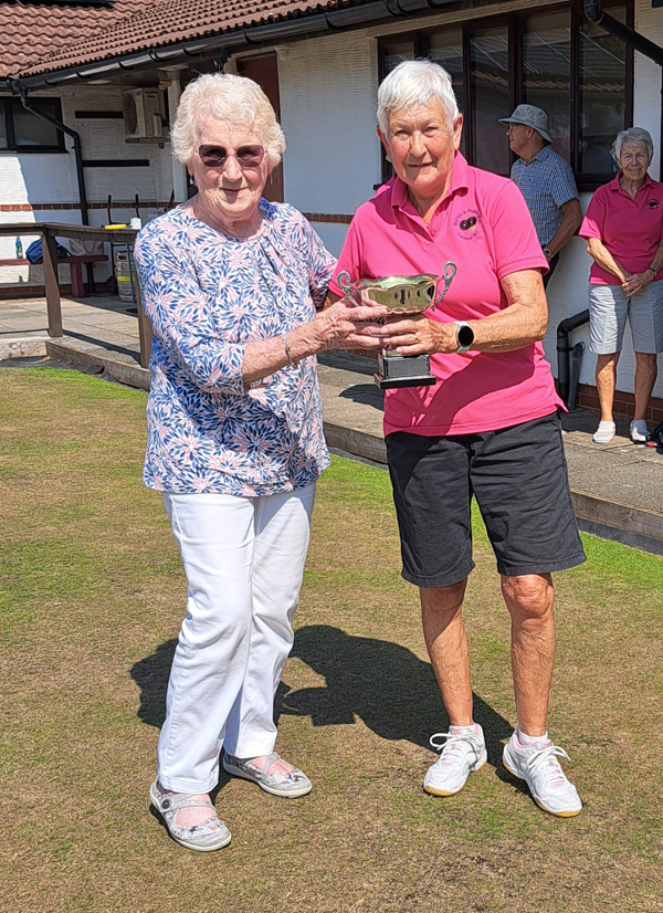 President of the League, Dot Lloyd, presenting the winner's trophy to Angela Atkinson