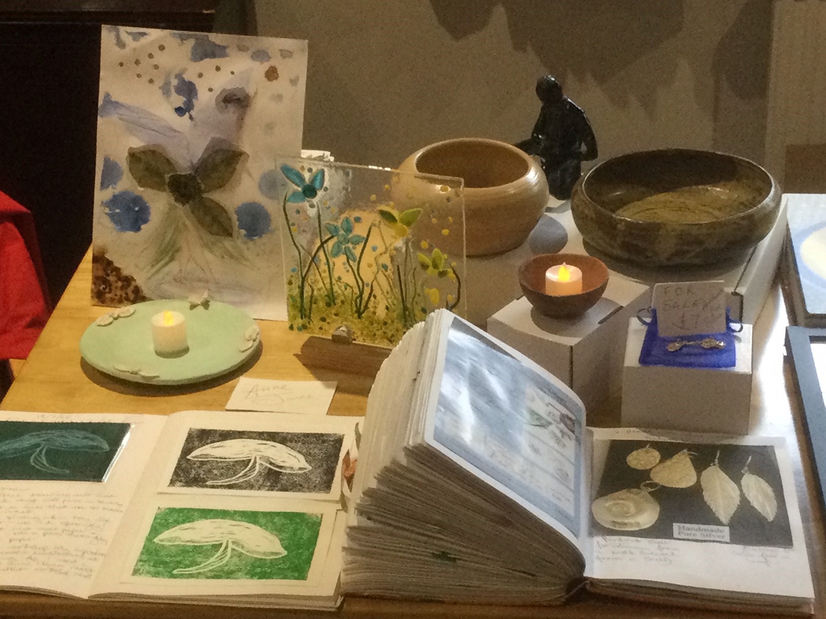 Handmade glassware, wooded bowls, candle holders, pressed flowers, jewelry and sketches.