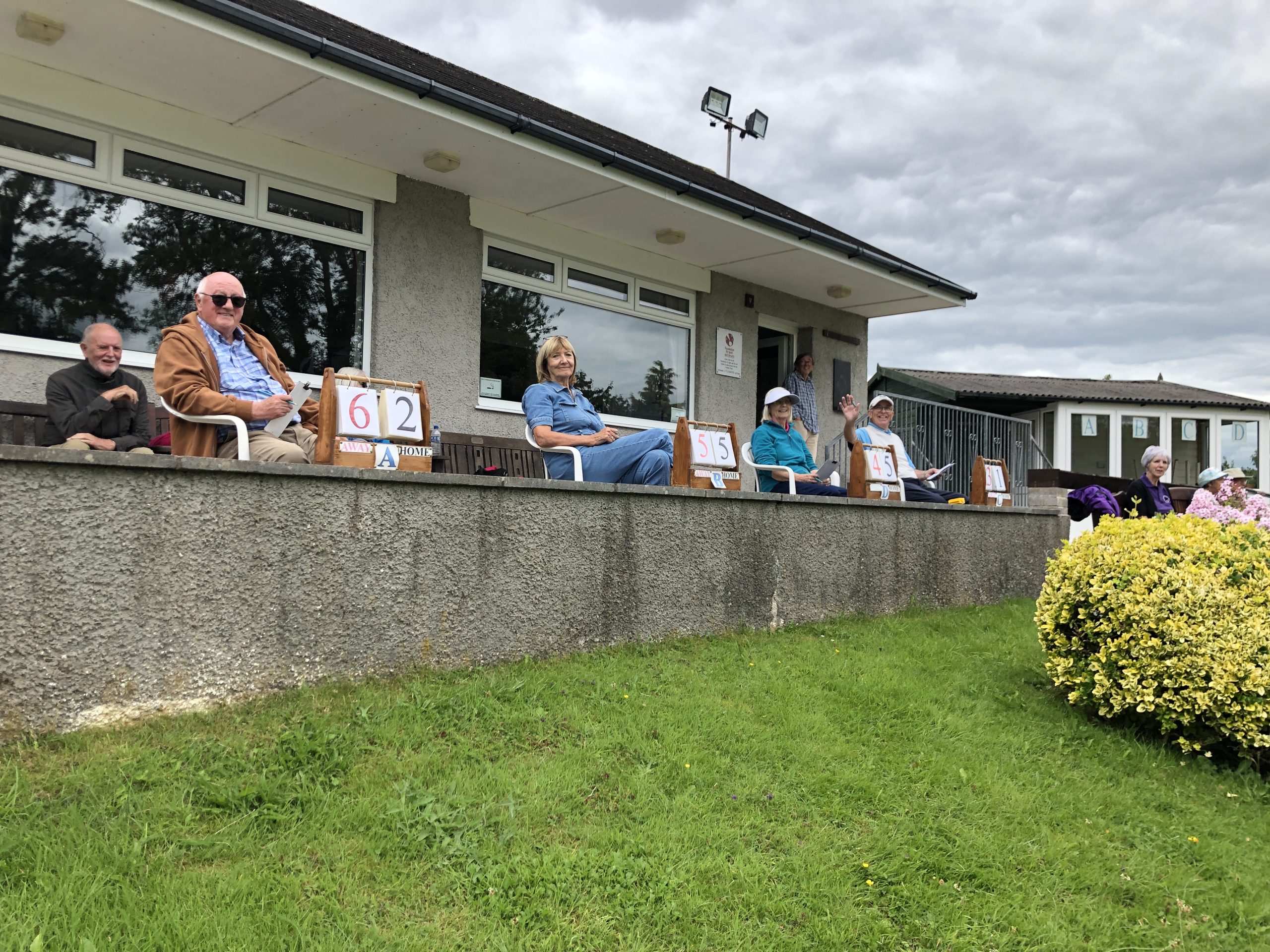 Four markers sitting in a row with scoreboards