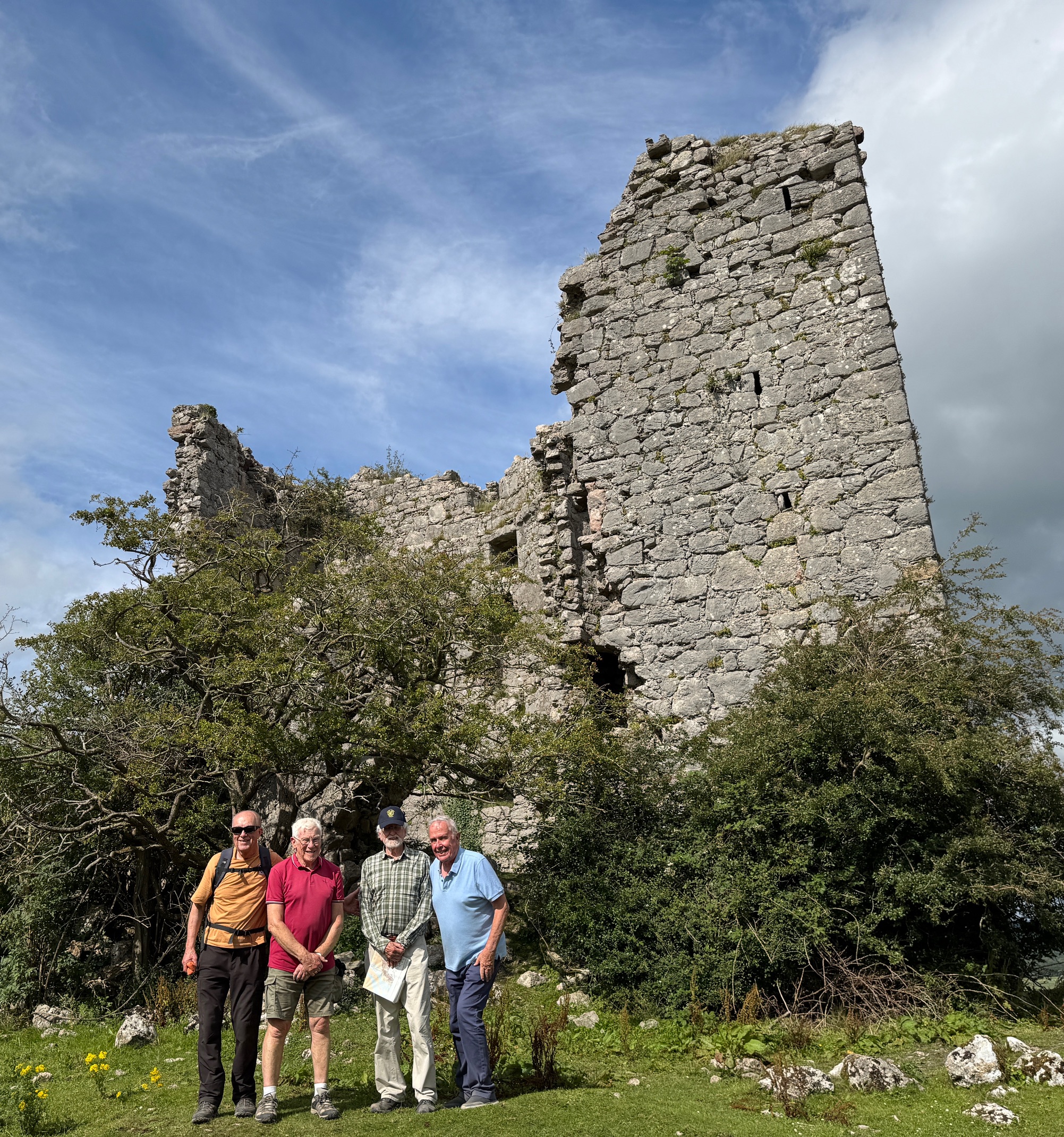 Four men standing in front of Arnside Tower