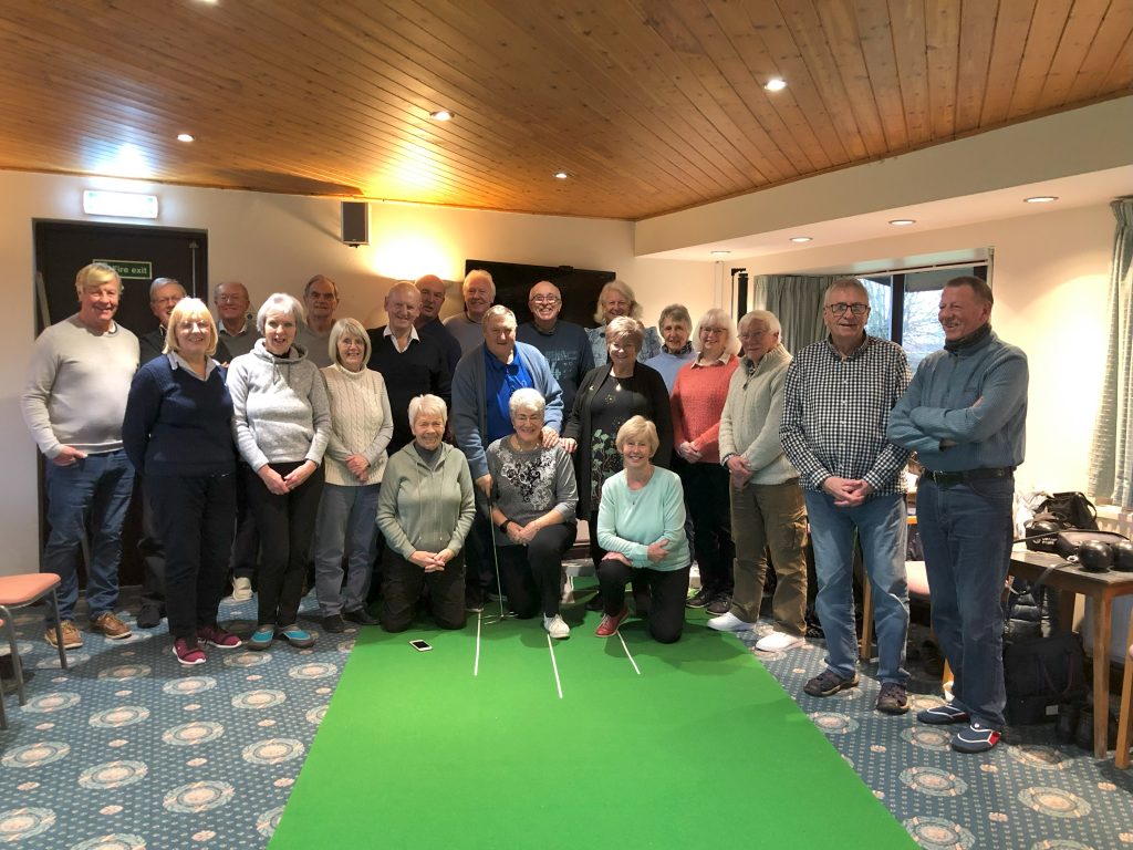 22 indoor bowlers gathered at one end of the mat.