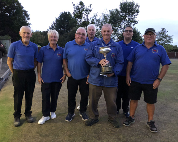 The team from Penyffordd gathered around their Captain, who is holding the Eldridge Cup.