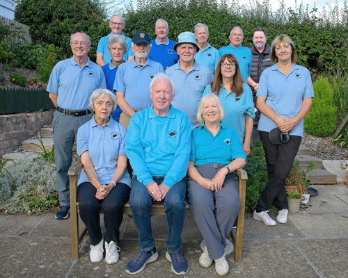 Members of the B&P Chester League team at the green - two woman and one man sitting on a bench with two women and four men standing behind them. Five men in the back row.