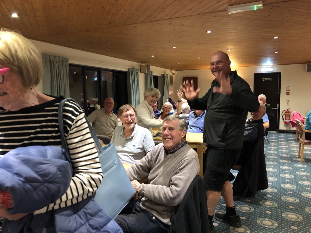 A picture taken looking up the Clubhouse to the back wall. Joan, David G, Geoff A, Bob C (standing), Steven, Helen, Chris W, Lief.