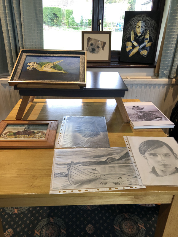 A table with a display of paintings.