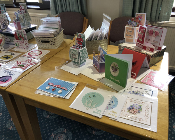 A table with a display of homemade cards.