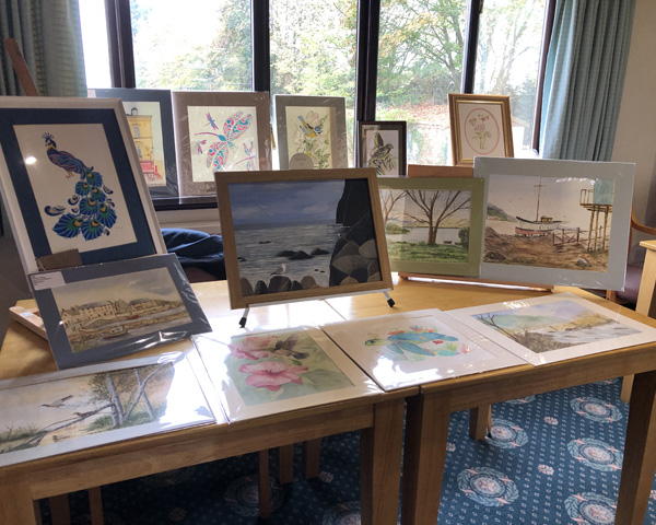 A table with a display of paintings.