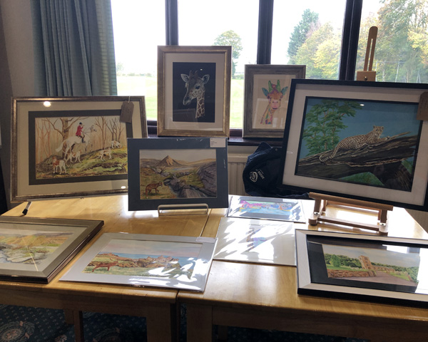 A table with a display of paintings.