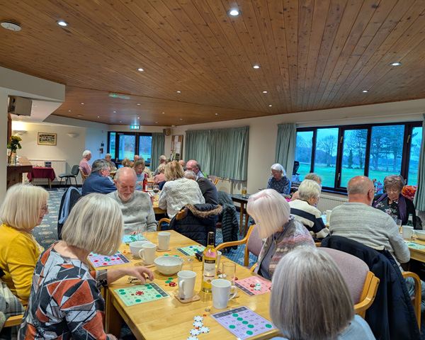 People sitting at tables playing bingo.