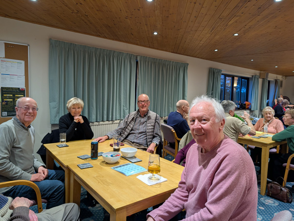 People sitting at table, smiling at the camera