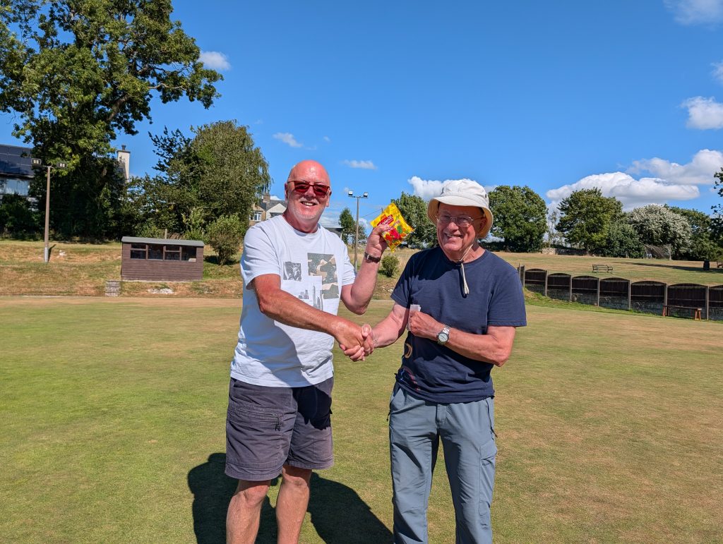 Chris with his prize for winning the Thursday competition. Shaking hands with Geoff.