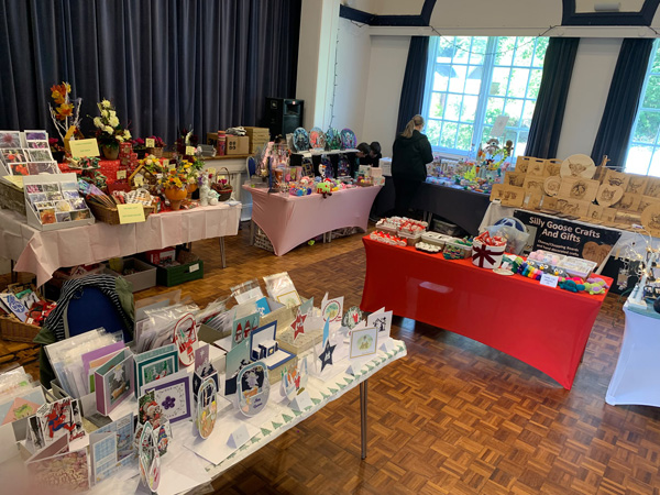 Tables at craft fair - cards, flower, crochet, wooden chopping boards etc