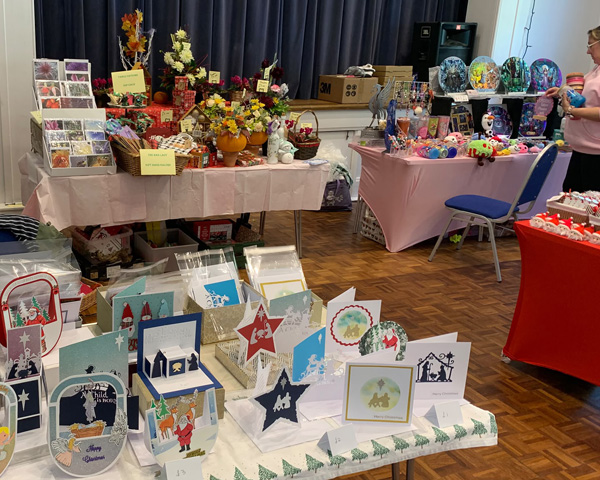 Tables at craft fair - cards, flower, crochet